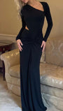 Three-quarter view of the black dress highlighting its asymmetric neckline and fitted silhouette
