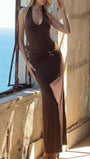 Model wearing the brown maxi dress with a high side slit, deep neckline, and ruched waist