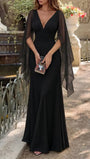 Full-length outdoor view of the black Celeste gown with a fitted bodice and fluid floor-length hem