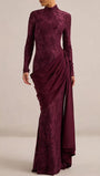 Model wearing the Merlot lace gown with long sleeves, sculpted waist draping, and full-length hem