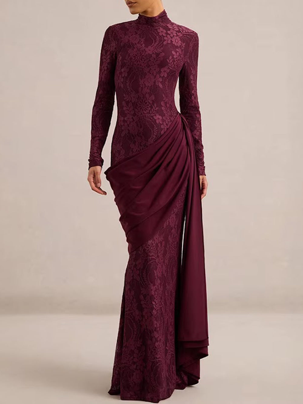 Model wearing the Merlot lace gown with long sleeves, sculpted waist draping, and full-length hem