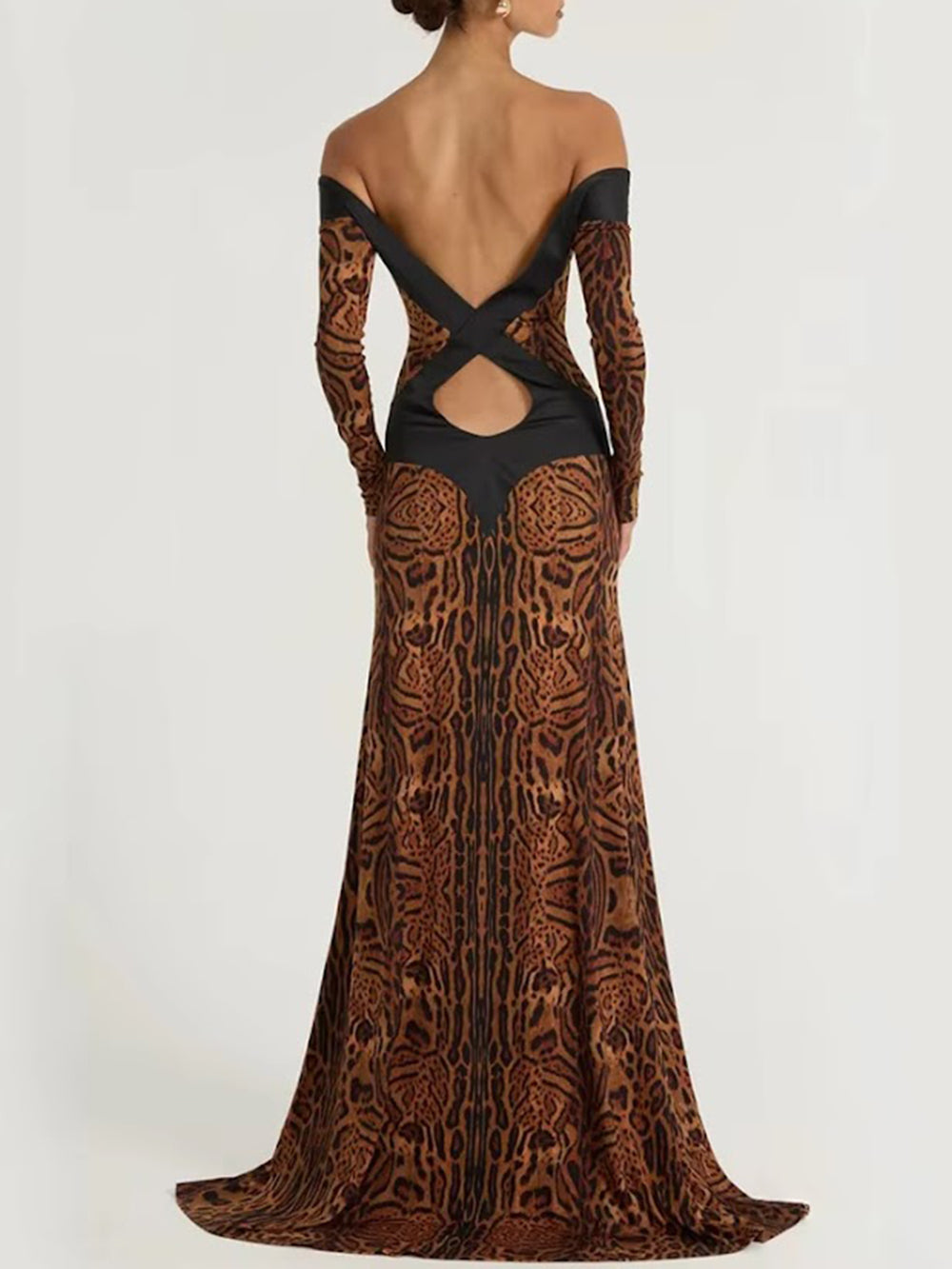 Back view of the Daria printed gown with long sleeves, crossed open-back bands, and a floor-sweeping hem