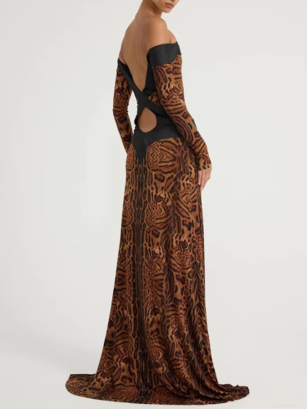 Side-back view of the brown and black printed gown showing off-the-shoulder styling and waist cutouts
