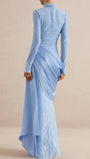 Back view of the powder blue lace gown with fitted long sleeves and cascading hip drape