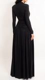 Back view of the black gown showing long sleeves and a full flowing skirt