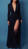 Model wearing the black blazer gown against a dark blue background