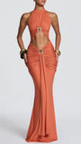 Front view of the terracotta halter maxi dress with large cutouts and gold-tone ring accents