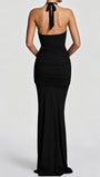 Back view of the black floor-length dress showing its halter tie and fitted silhouette