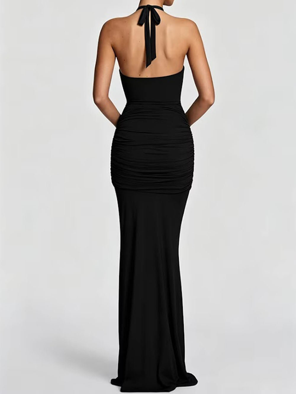 Back view of the black floor-length dress showing its halter tie and fitted silhouette