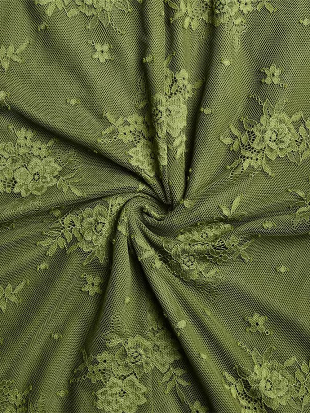Close up of olive floral lace fabric showing the delicate patterned texture