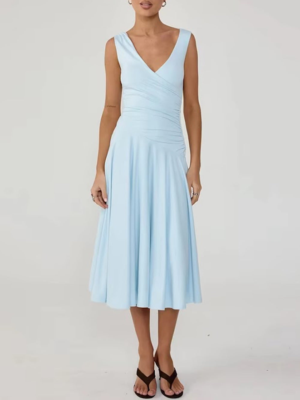 Front studio view of the powder blue wrap-style midi dress with gathered waist detailing