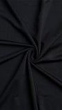 Close up of black stretch fabric twisted to show its smooth fluid texture