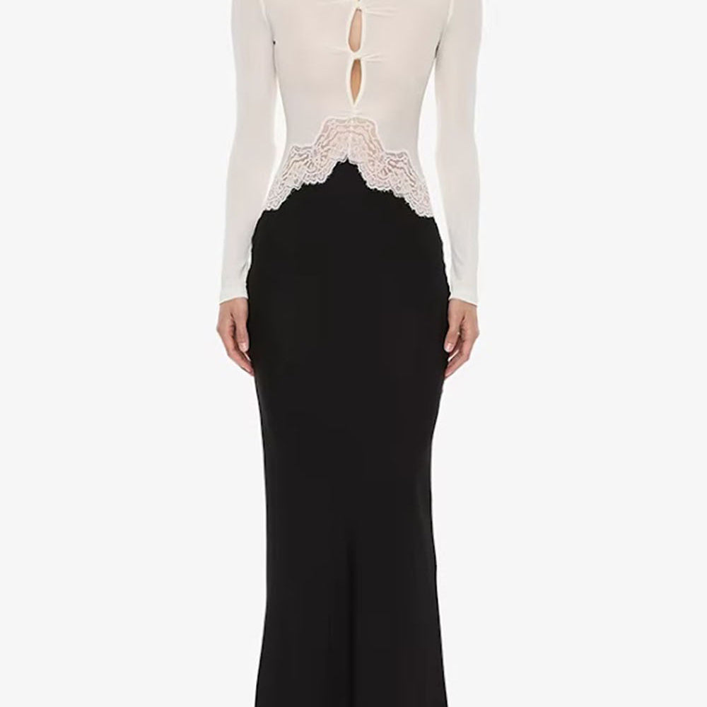 Front view of the monochrome dress showing white buttoned bodice, cutouts, and black fitted skirt