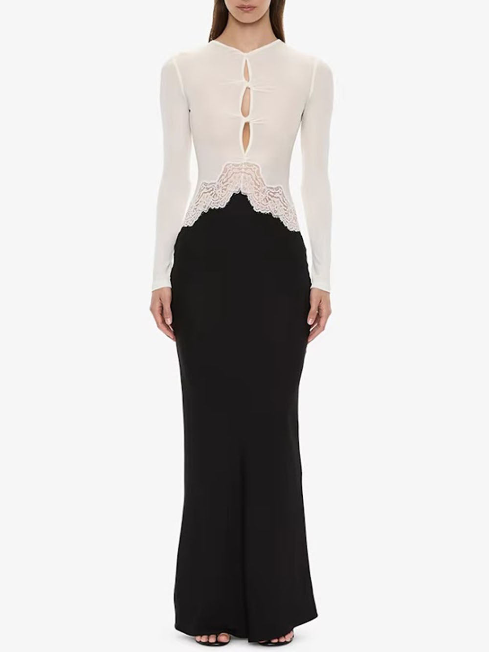 Front view of the monochrome dress showing white buttoned bodice, cutouts, and black fitted skirt