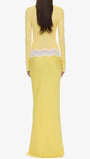 Back view of the butter yellow floor-length dress with white lace trim at the waist