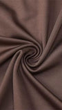 Close up of smooth mink brown fabric twisted into soft folds