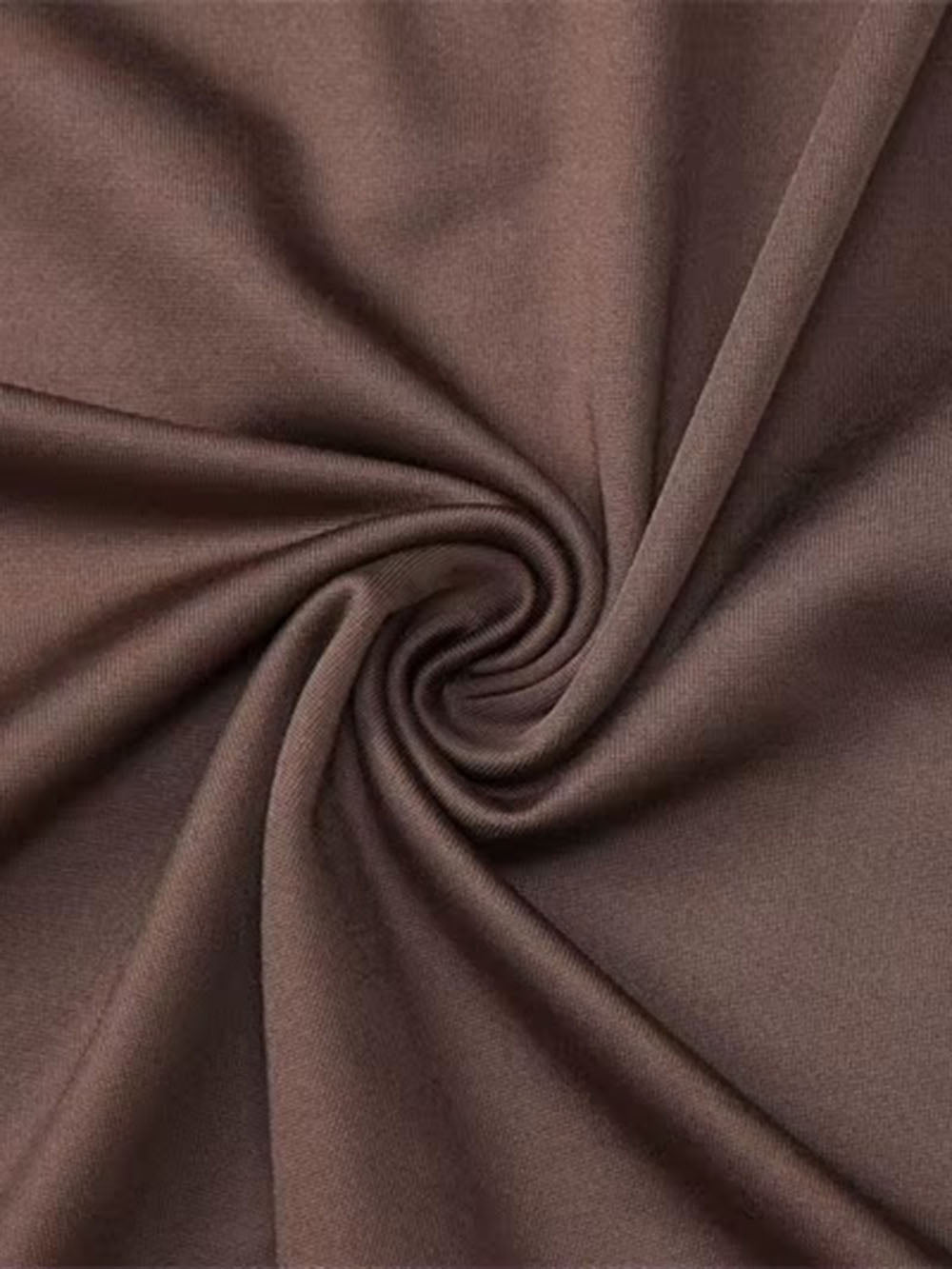 Close up of smooth mink brown fabric twisted into soft folds