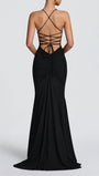 Back view of the black gown showing a dramatic lattice strap design and fitted skirt
