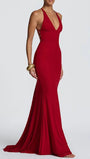 Three-quarter view of the crimson gown highlighting its fitted body and long train-like finish