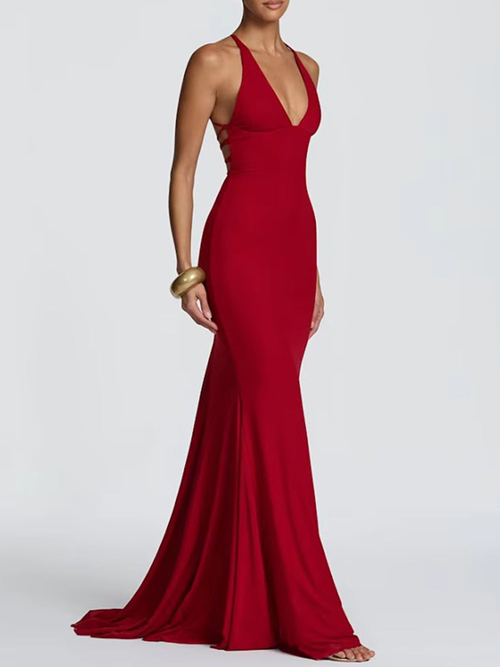 Three-quarter view of the crimson gown highlighting its fitted body and long train-like finish
